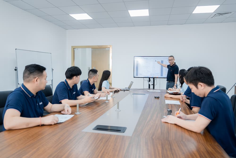 Multiple R&D engineers discuss customer drawings